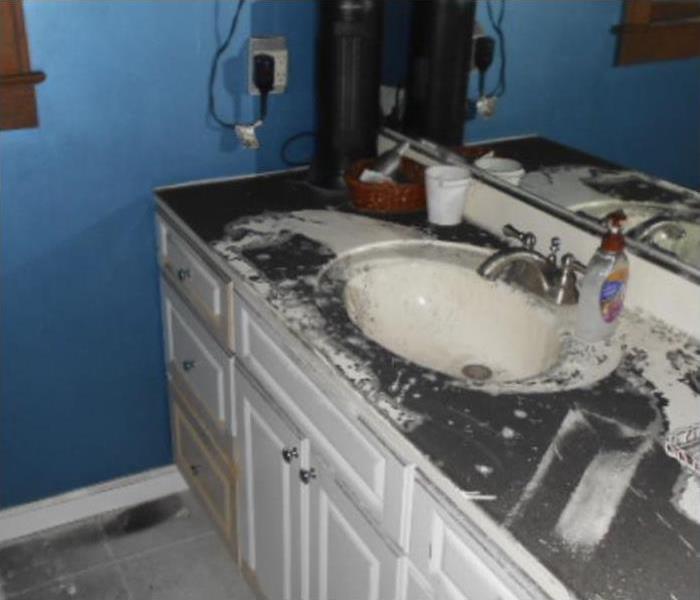 Soot damage on the counter of a bathroom